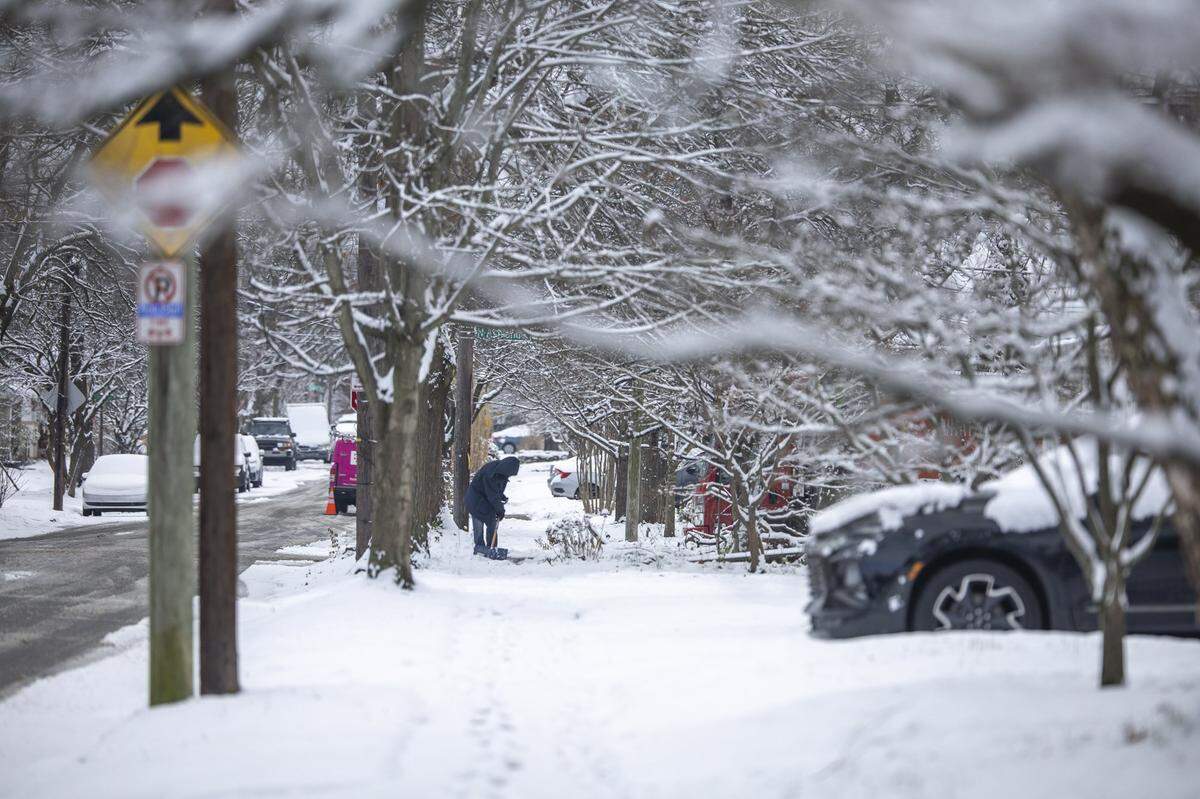 Snow covers a sidewalk in Lexington, Ky., Friday, Dec. 12, 2025.