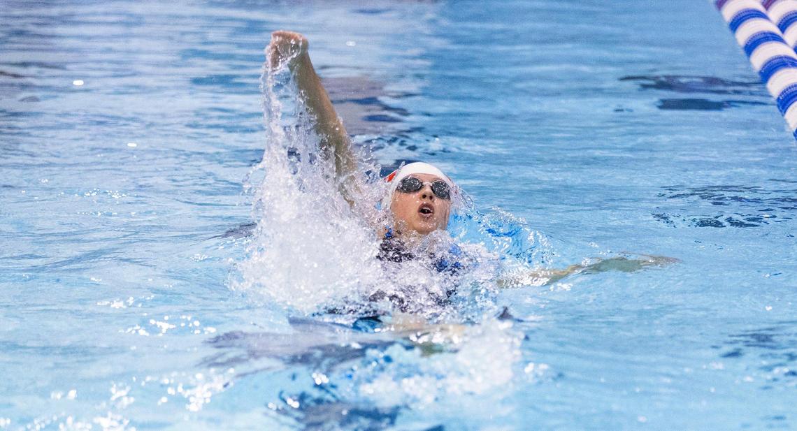 Dunbar’s Kennedy Brooks competes in the 100 backstroke championship final heat during the 2025 KHSAA State Swimming Championships at the University of Kentucky’s Lancaster Aquatic Center on Friday, Feb. 21, 2025.