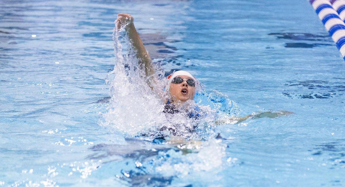 Dunbar’s Kennedy Brooks competes in the 100 backstroke championship final heat during the 2025 KHSAA State Swimming Championships at the University of Kentucky’s Lancaster Aquatic Center on Friday, Feb. 21, 2025.