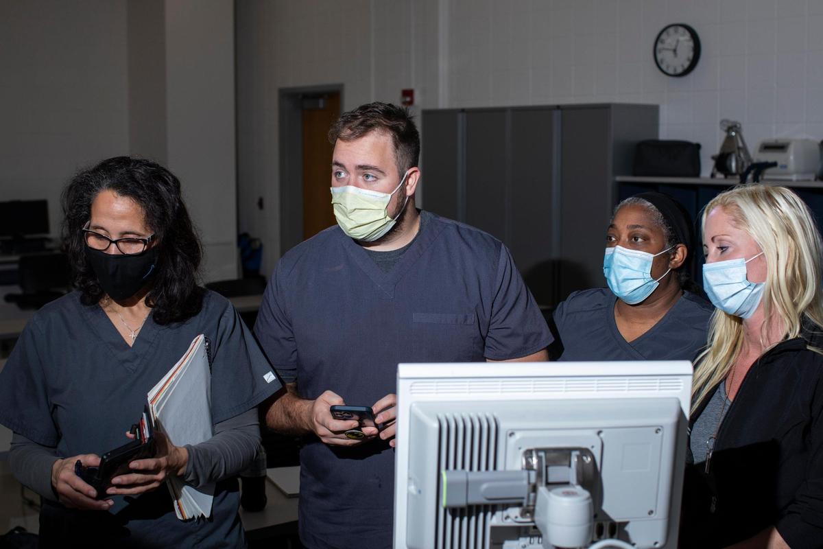 Professor Trisha Dang talks with respiratory care students working through situations with a ventilator at BCTC in Lexington, Ky., Wednesday, October 6, 2021.