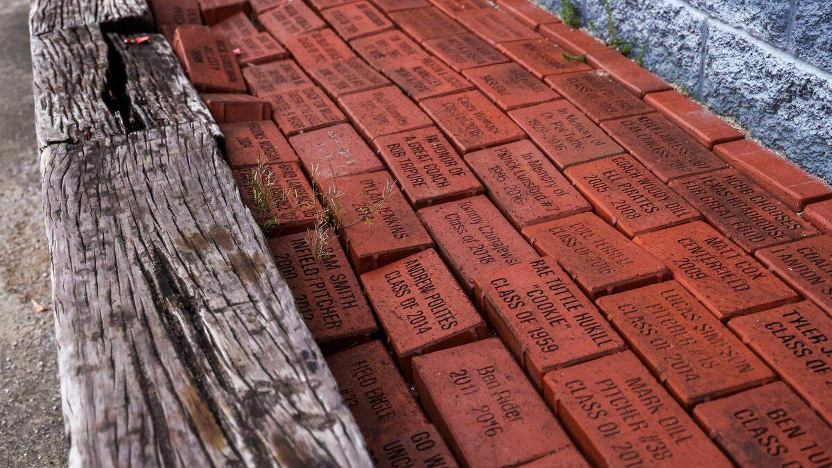 Donation bricks lay behind the press box at Henry Clay’s baseball field. Demolition of the school’s baseball and softball fields is scheduled to begin June 1, and the teams will not have new field until 2029.