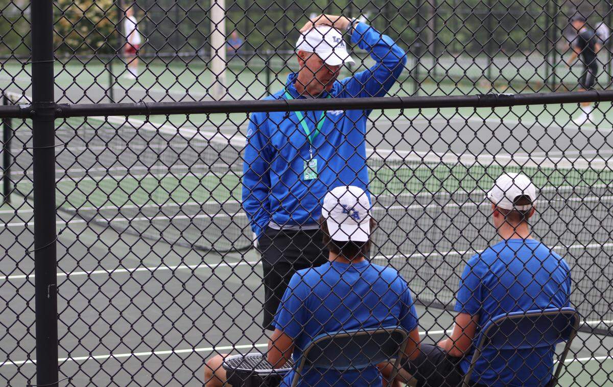 Lexington Christian tennis coach and former University of Kentucky basketball star Kyle Macy spoke with Levi Messner, left, and Ben Philpot.