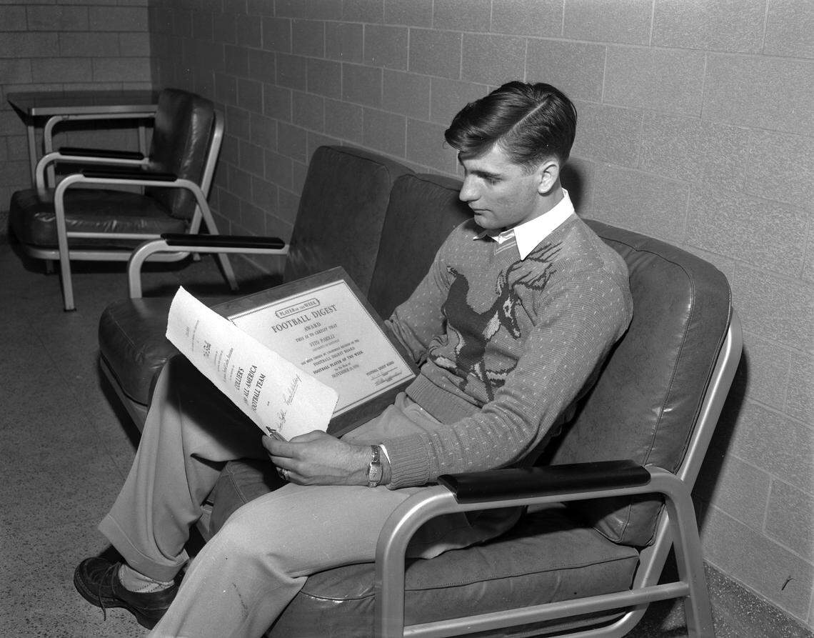 Kentucky quarterback Babe Parilli read "Football Digest" in January 1951. Parilli was a first-team All-American in 1950 and 1951. 