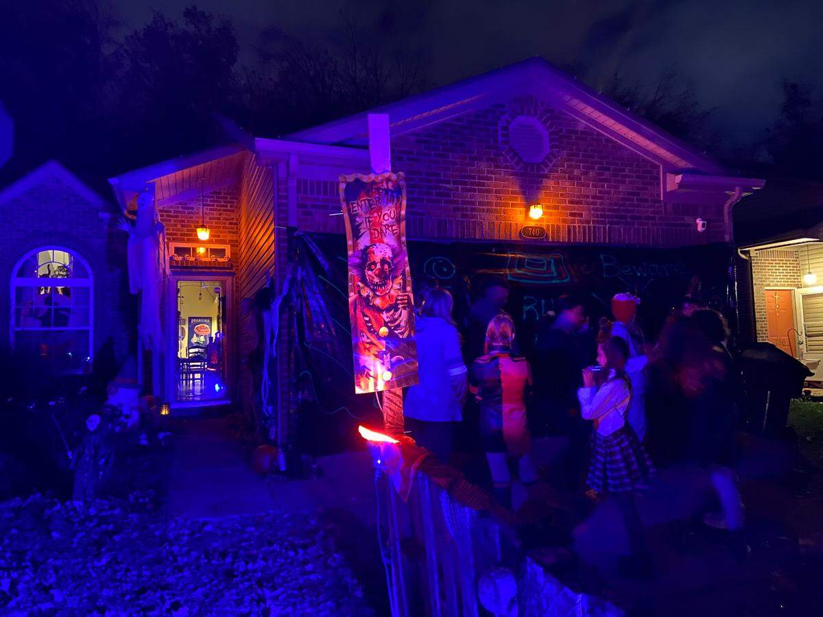 Ty Abner spent weeks designing the haunted house in his garage on Nickwood Trail where people gathered Sunday night.