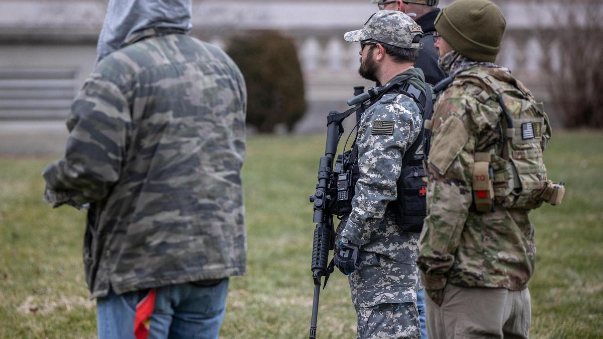 Armed protesters listen to a speaker during a demonstration outside the Kentucky State Capitol on Saturday, Jan. 9, 2021.