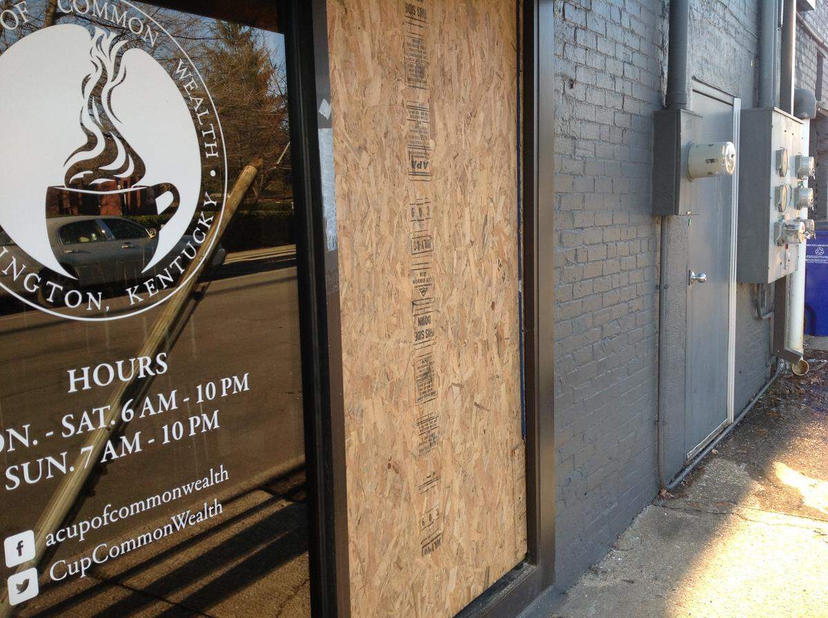 A Cup of Common Wealth on Eastern Avenue in Lexington had plywood over a window after the coffee shop was burglarized. Whoever broke in had first tried the front door.