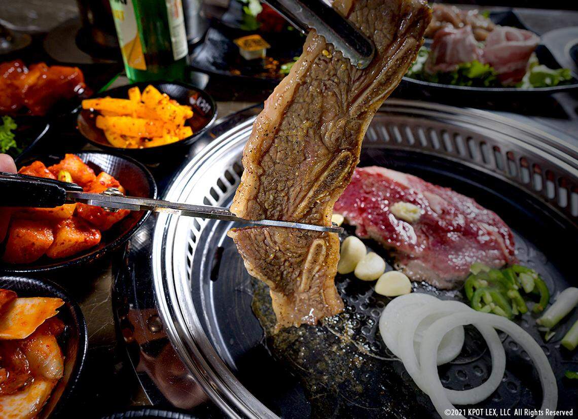At KPOT Korean BBQ & Hot Pot, diners select the proteins and vegetables they want and cook them together at the table, either on a sizzling pan or in a broth with noodles