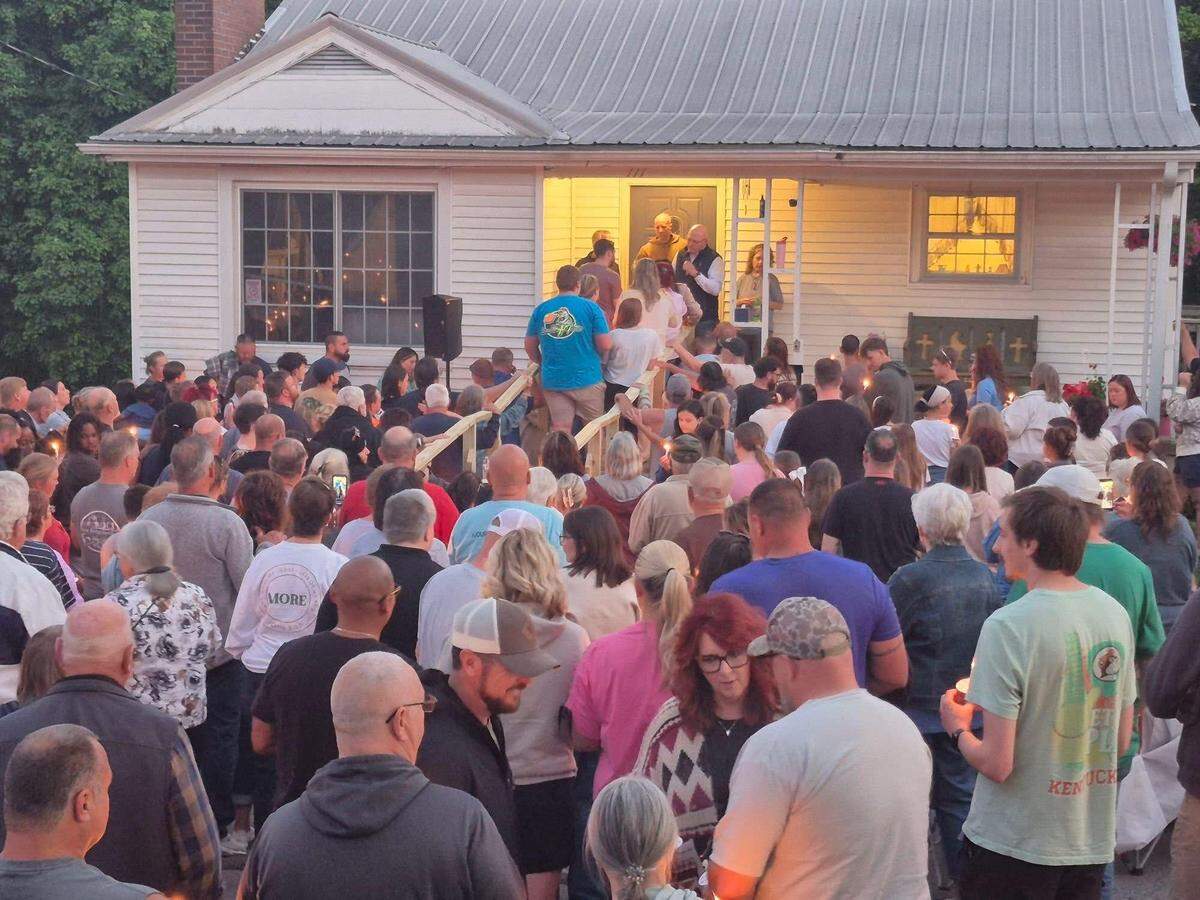 Hundreds of people gather for a prayer service in front of the home of the Stanford, Ky., mayor.