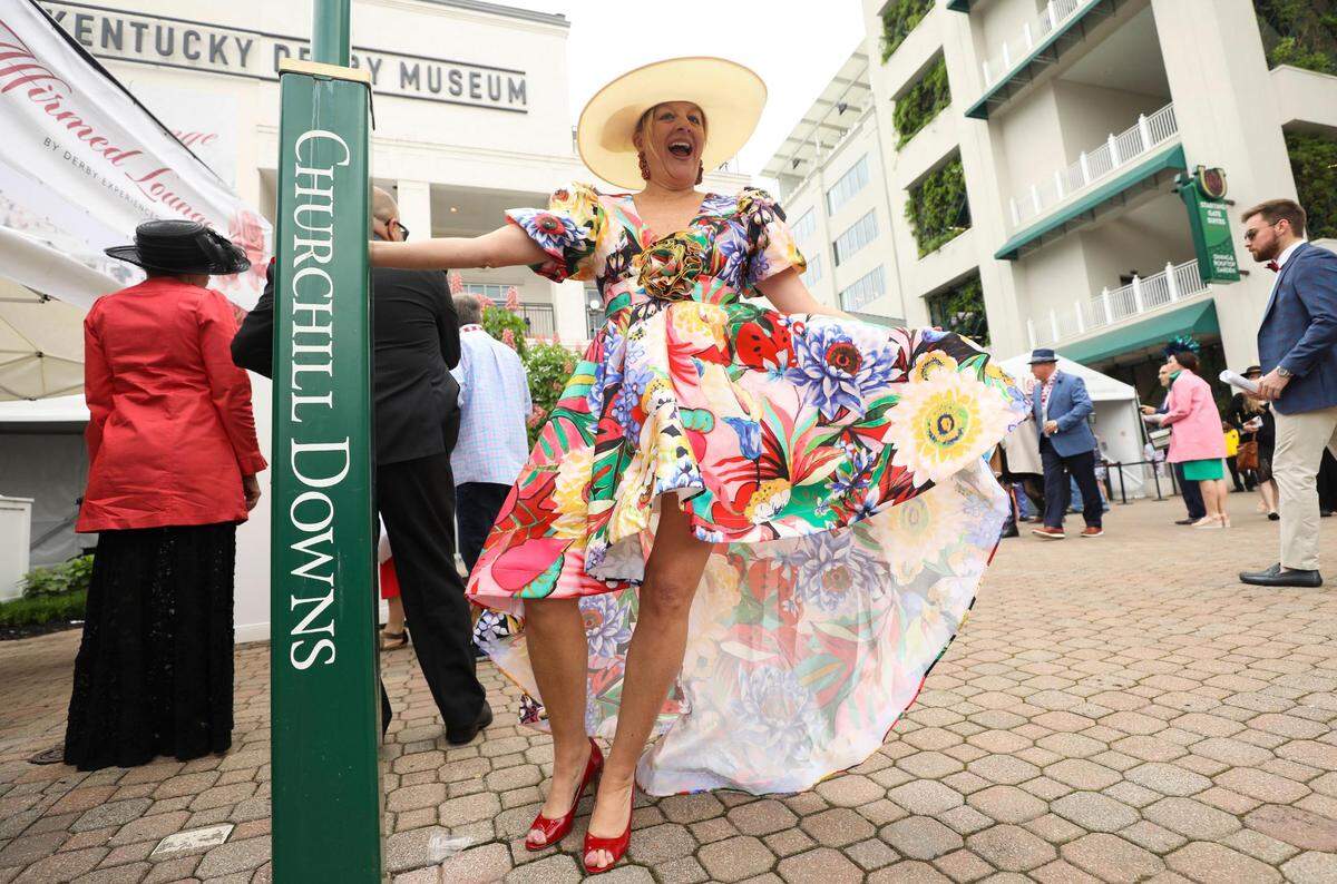 Angie Bush wears a flowered dress at Churchill Downs in Louisville, Ky., Saturday, May 7, 2022. She said she found the dress for $70 an “it screamed Derby.”