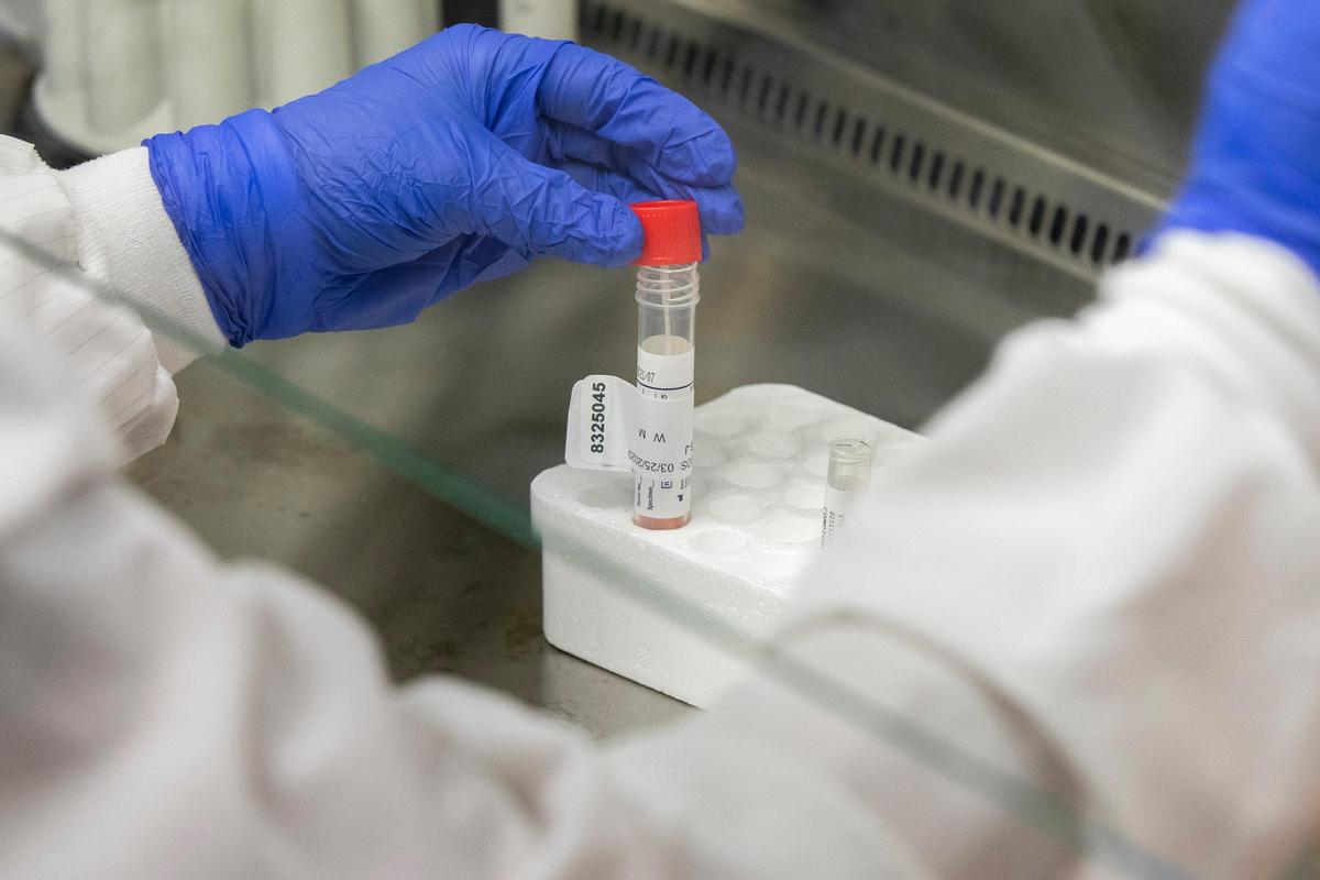 Ben Cobb, lead molecular microbiologist, prepares a specimen for Covid-19 testing at the University of Kentucky Medical Center Clinical Microbiology Lab in Lexington, Ky., on Tuesday, March 25, 2020.