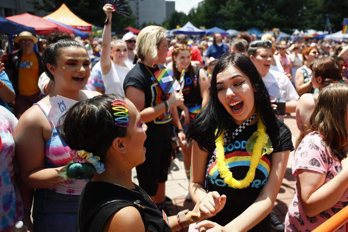 Lesly Castillo, 14, left, sings along with Isabel Carrillo, 14, center, both of Lexington, during a drag show during the 2019 Lexington Pride Festival at Courthouse Plaza in downtown Lexington, Saturday, June 29, 2019.