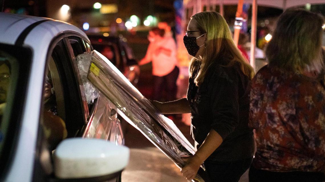 Teachers hand out packets and some goodies during the Virtual Learning Academy Open House outside the Fayette County Public Schools Warehouse in Lexington, Ky., Thursday, October 22, 2020. Due to the infection rates in the Lexington community and across Kentucky, the Fayette County Board of Education voted not to resume in-person learning immediately. FCPS is offering a completely virtual learning option for the 2020-21 school year.
