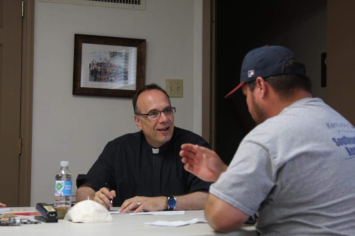 Father Jim Sichko, a Catholic priest and motivational speaker based in Lexington, paid the electric bills of about 200 out-of-work coal miners in Harlan on Monday.