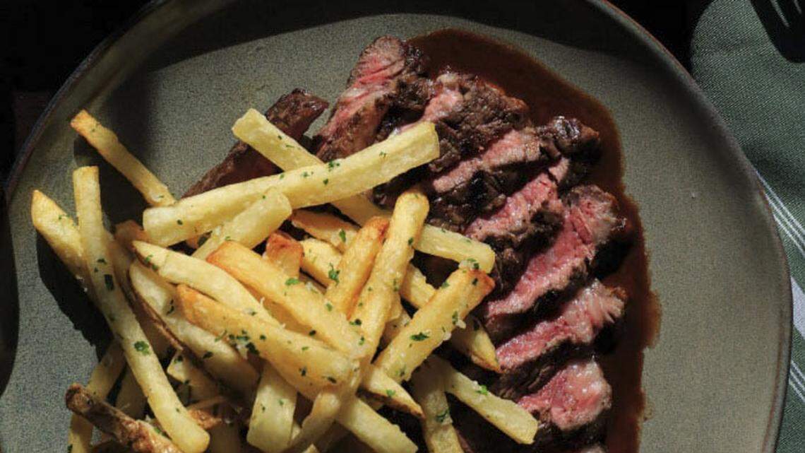 A chargrilled ribeye ($62) with Millstone butter, demi, hand-cut tallow fries, chives and Parmesan.