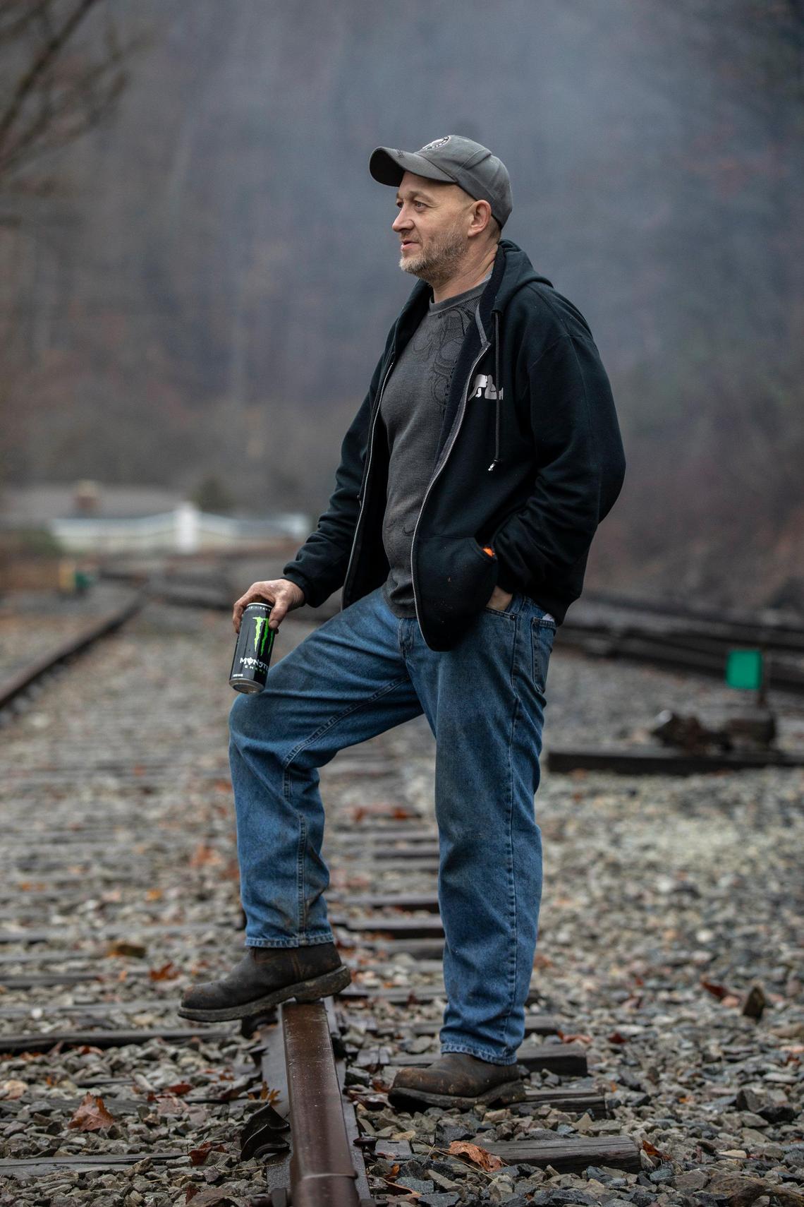 Kenny Collins, an employee of Quest Energy, stands on railroad tracks where miners, who say they haven’t been paid in three weeks, block a coal train in Pike County, Ky., Tuesday, Jan. 14, 2020.