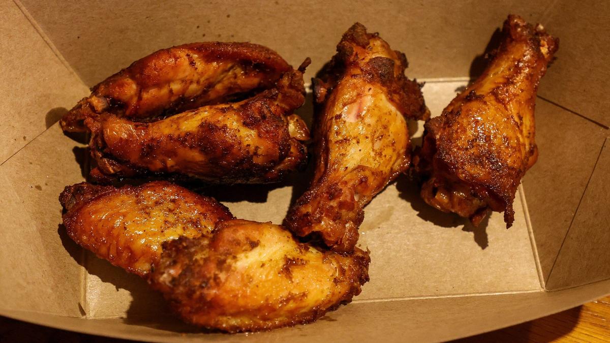An order of smoked chicken wings from Double H BBQ on Lexington’s Versailles Road. The barbecue restaurant frequently sells out of the wings, which are first marinated, smoked and then flash fried when ordered.