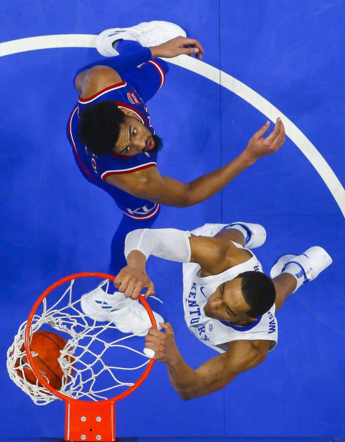 Kentucky's PJ Washington beat Kansas' Dedric Lawson for a dunk during the second half in Rupp Arena on Saturday.
