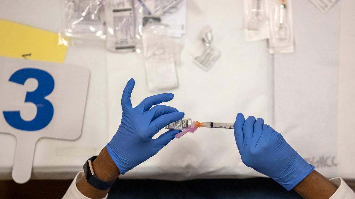 Gwen Holloman, a registered nurse, draws a dose of the COVID-19 vaccine at a vaccination clinic operated by the Lexington-Fayette County Health Department at Consolidated Baptist Church in Lexington, Ky., on Wednesday, Feb. 3, 2021.