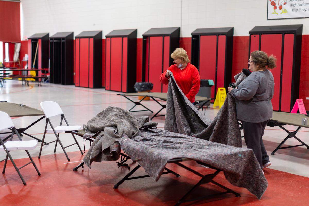 Volunteers fold blankets and clean cots at a warming station set up at the Tyner Elementary school where people can come if they have lost power in Jackson County Jackson, Ky., Wednesday, February 17, 2020. Volunteers at the warming station provided people who stayed there with food and blankets. This was the only large facility in the county that did not lose power after the winter storm. The National Weather Service has forecasted another winter storm to drop snow Wednesday night and Thursday.