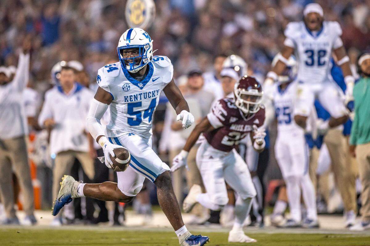 Kentucky linebacker D’Eryk Jackson (54) smiles as he returns an interception for a touchdown during Saturday’s game against Mississippi State.