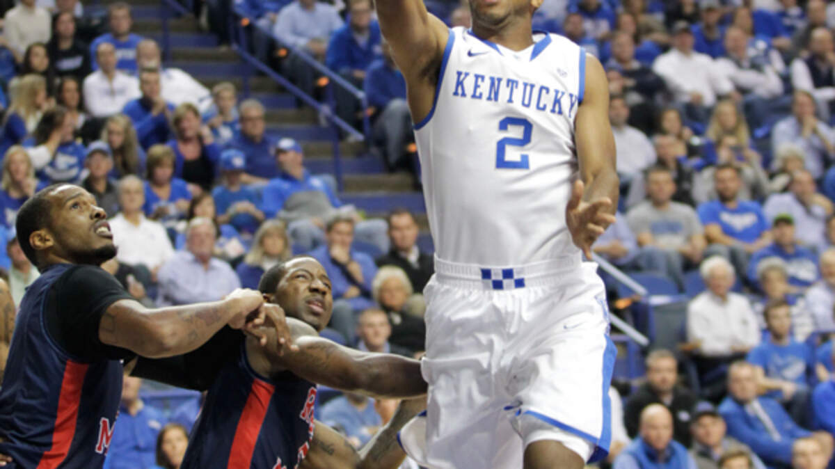 Kentucky's Aaron Harrison tried for two over Robert Morris defenders during Sunday  night's game in Rupp Arena. Photo by Pablo Alcala | Staff