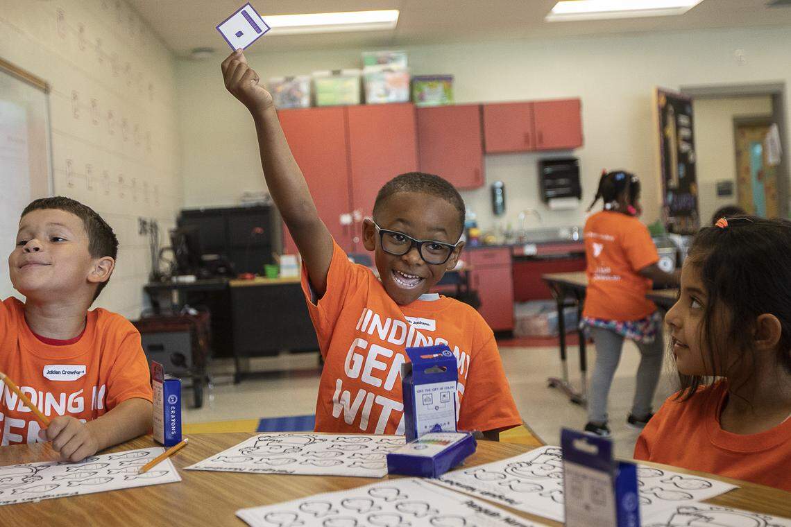 Elijah Jackson, a rising first-grade student, holds up a card while practicing number skills during the YMCA of Central Kentucky’s Power Scholars Academy at Coventry Oak Elementary School Wednesday, June 19, 2019.