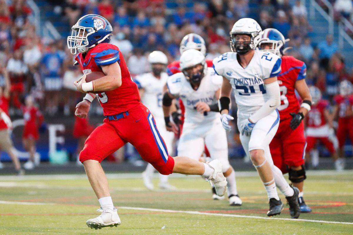 Christian Academy-Louisville’s Gavin Copenhaver, left, runs for a touchdown against Lexington Christian last season.