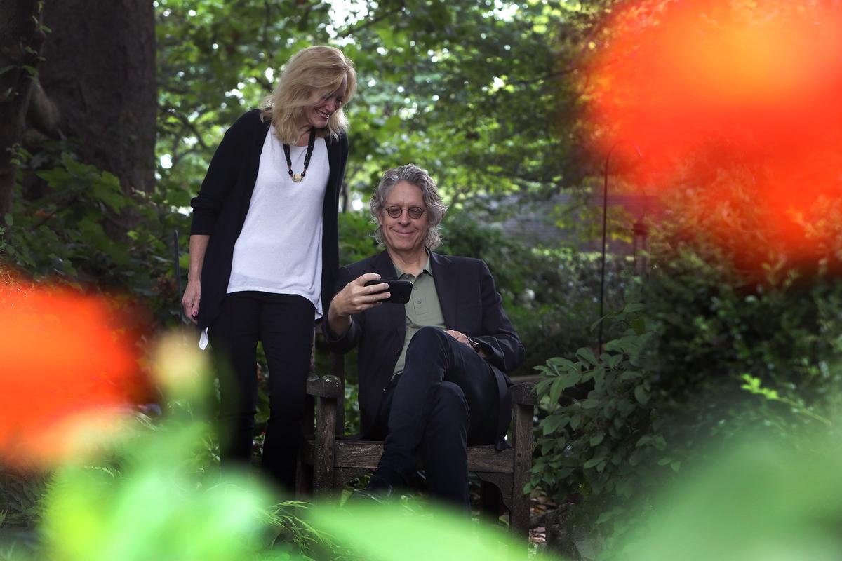 Lee Carroll and Connie Milligan took a selfie while having their portrait made. The couple are welcoming musical acts they have encountered on their to travels to places like Africa and Cuba to visit and perform in Lexington as part of Green Room Exchange, a new concert series they created.