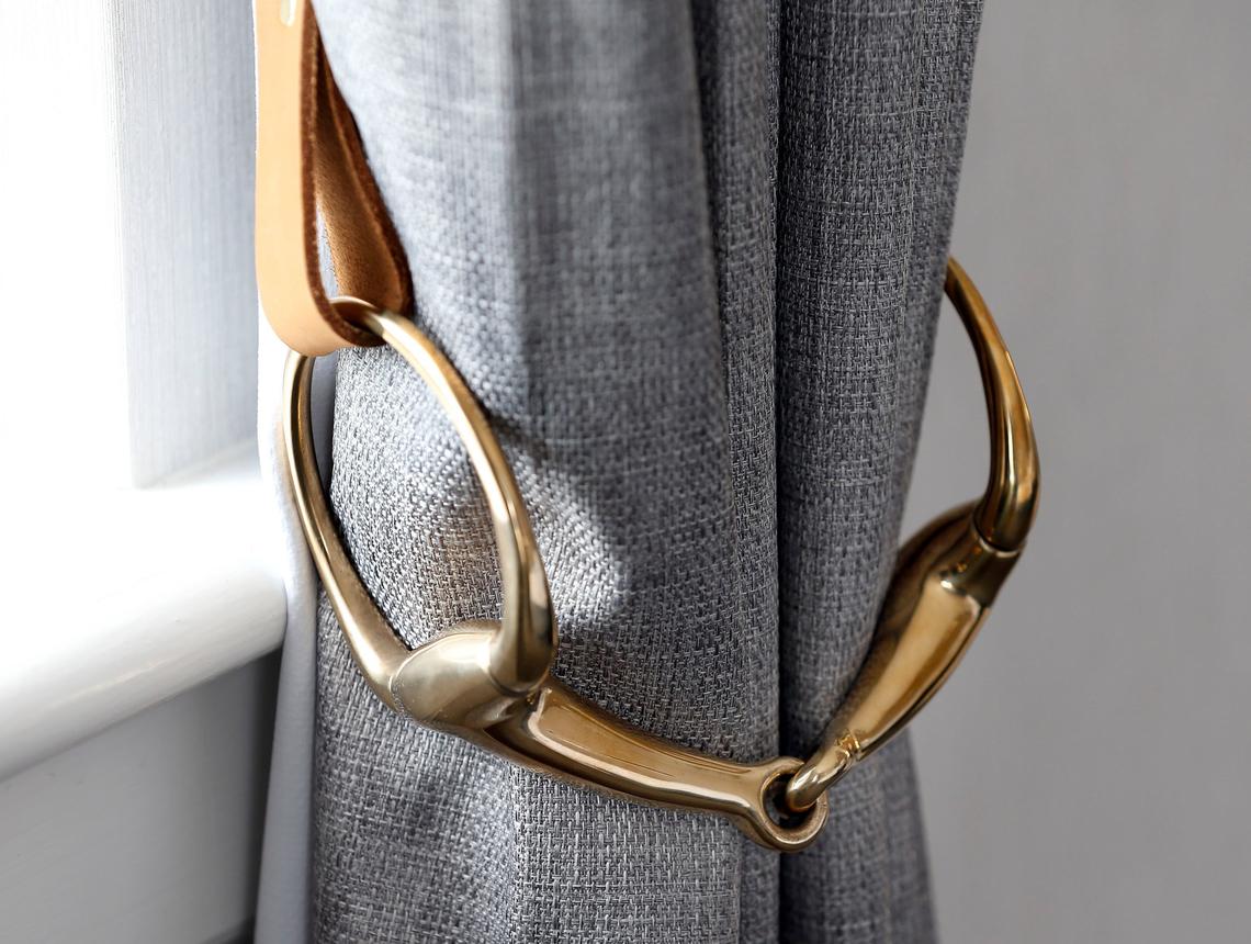 The curtain tie backs are patterned after horse bits, one of the subtle equestrian touches at at The Sire, formerly the Gratz Park Inn.