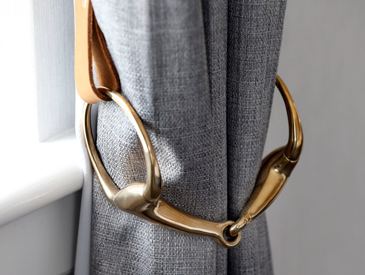 The curtain tie backs are patterned after horse bits, one of the subtle equestrian touches at at The Sire, formerly the Gratz Park Inn.