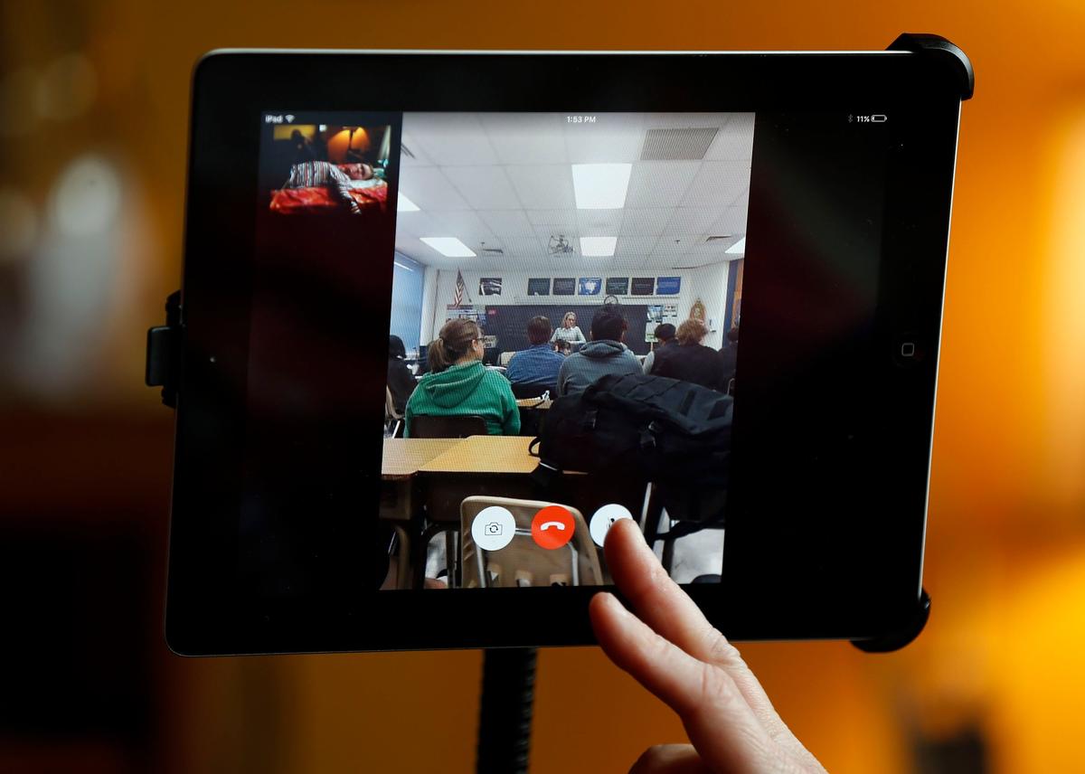 Lafayette High School freshman Danielle Pruitt, on the small screen on the top left, took part in class Thursday afternoon via FaceTime from her home in Lexington.