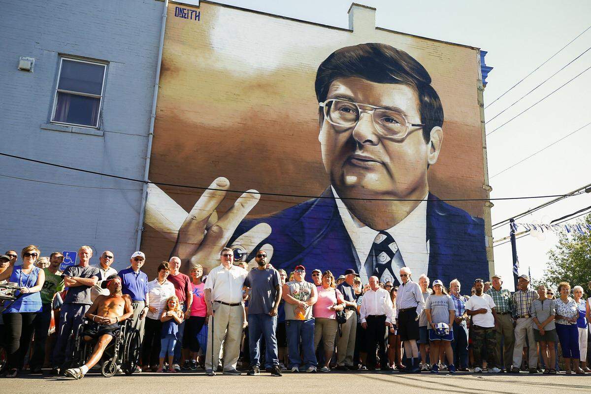 Former University of Kentucky head basketball coach Joe B. Hall posed for a picture with friends, family members and fans in front of a mural featuring his image in downtown Cynthiana in 2017.