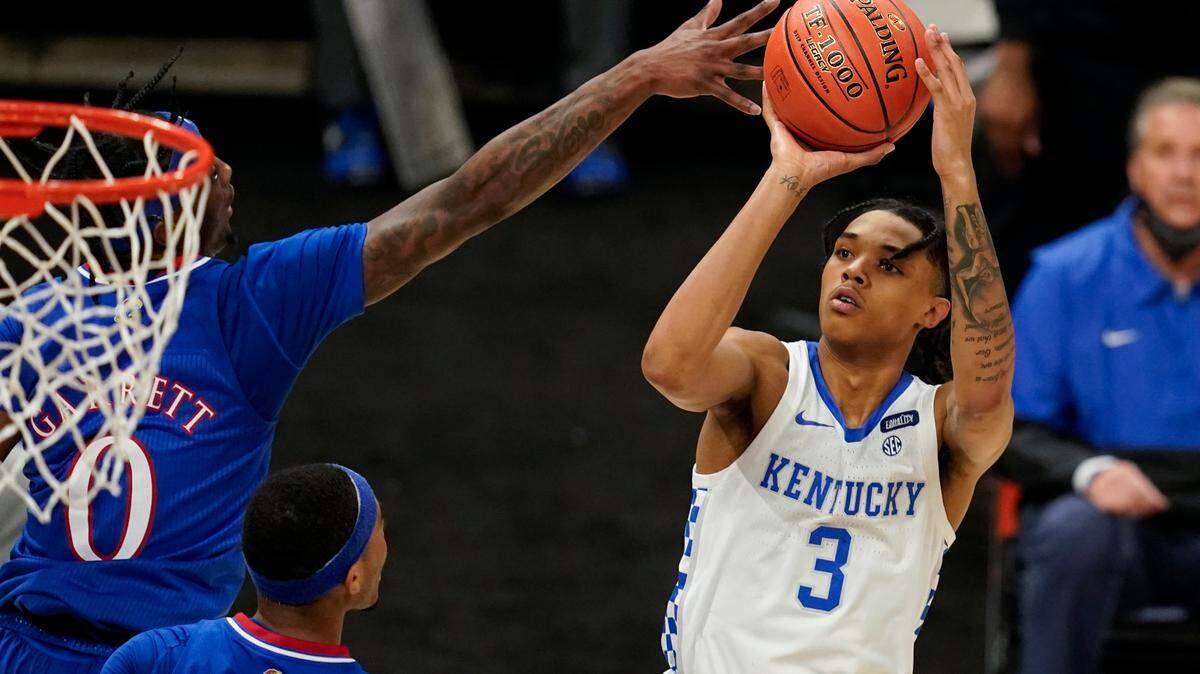 Kentucky’s Brandon Boston Jr. (3) shoots against Kansas’ Marcus Garrett (0) during the second half of an NCAA college basketball game Tuesday, Dec. 1, 2020, in Indianapolis. (AP Photo/Darron Cummings)