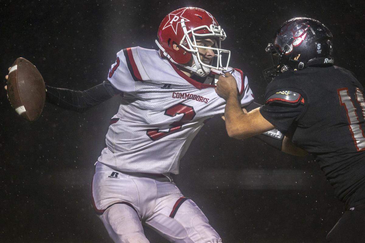 Harlan County’s Jacob Bailey sacks Perry County quarterback Cameron Brown.