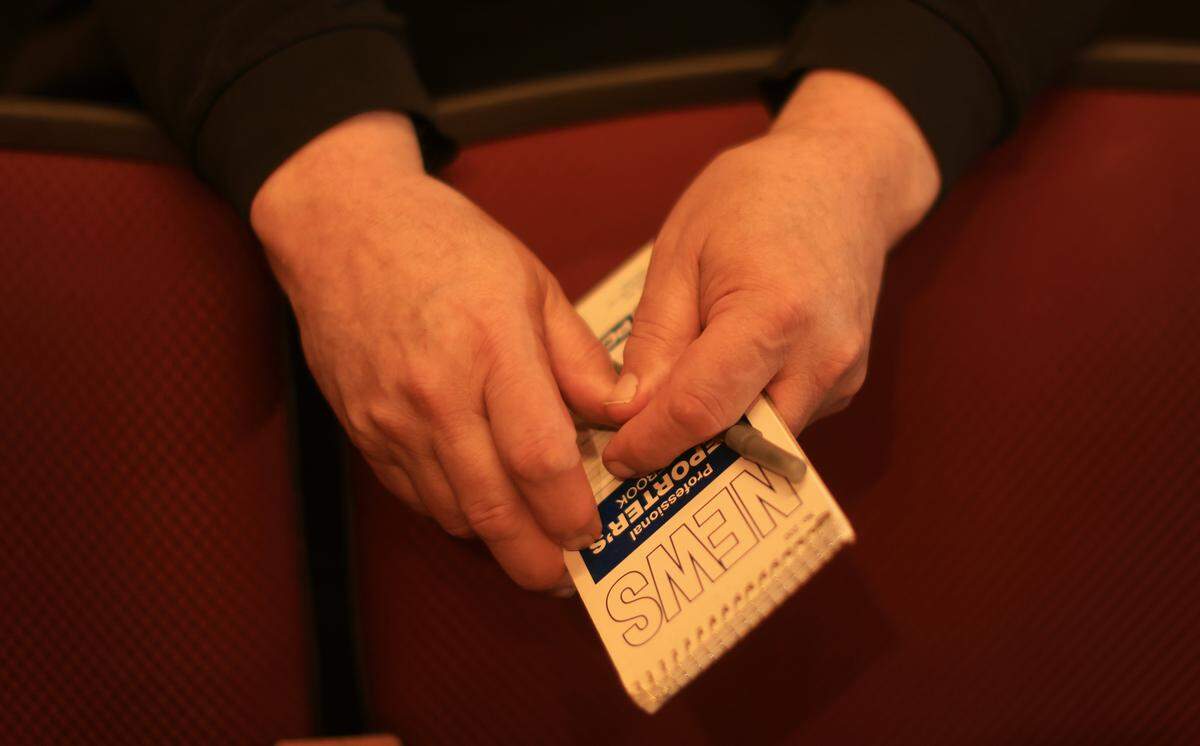 Walter Tunis hold a reporter’s notebook, in the the Singletary Center for the Arts on the University of Kentucky campus, May 21, 2026.