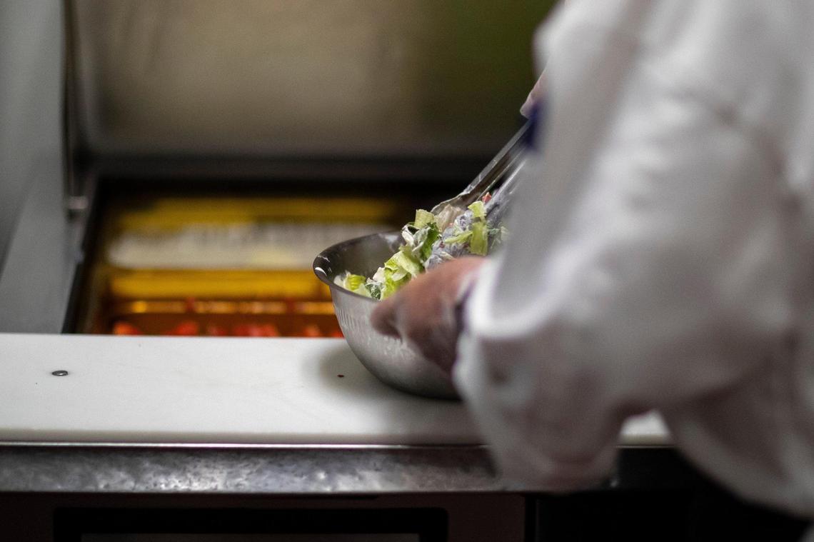 Alan Lamoureux, BHG culinary director, prepares a Lexingtonian salad at Malone’s in Lexington, Ky., on Tuesday, Sept. 28, 2021.