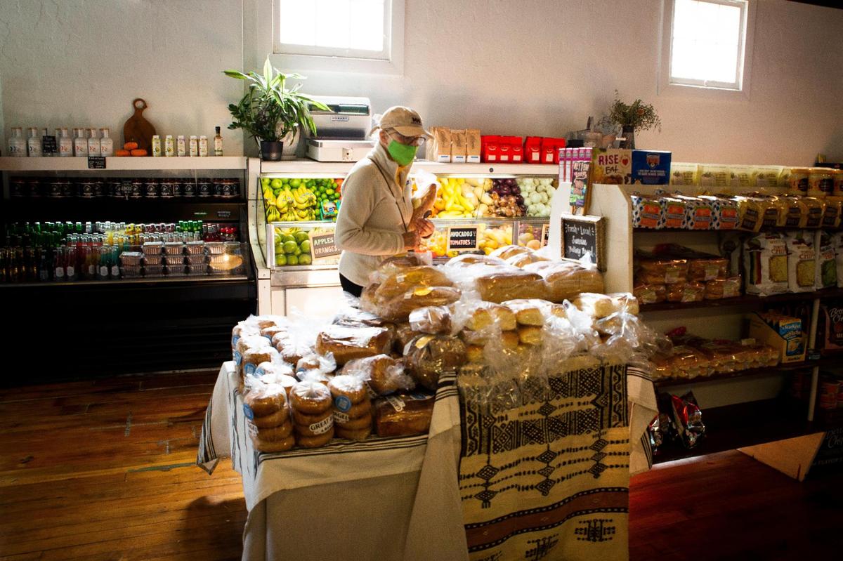 Cindy Miller shops the assortment of local bread available at Wilson’s Grocery Sept. 20.
