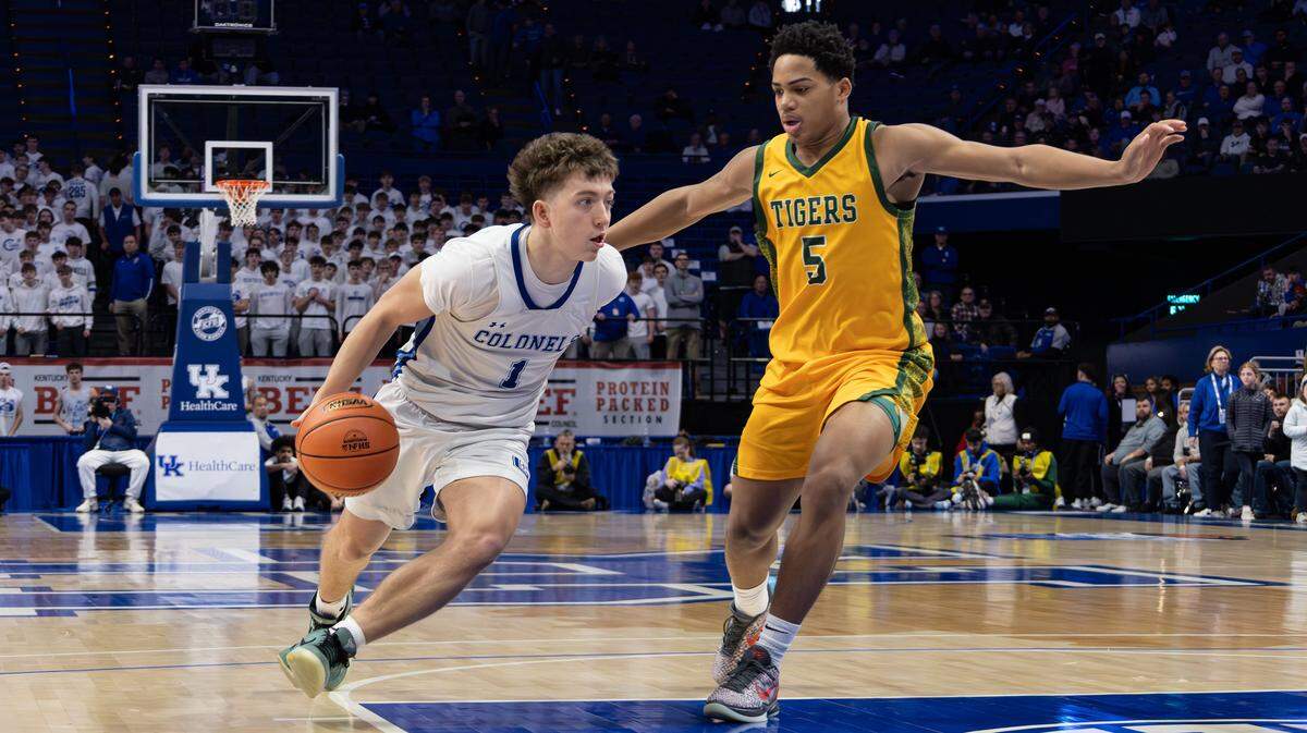 Covington's Athens McGillis drives to the basket, guarded by St. Xavier's Joshua Lindsay during the UK HealthCare Boys' Basketball Sweet 16 state tournament first-round game between Covington Catholic and St. Xavier at Rupp Arena on March 18, 2026.