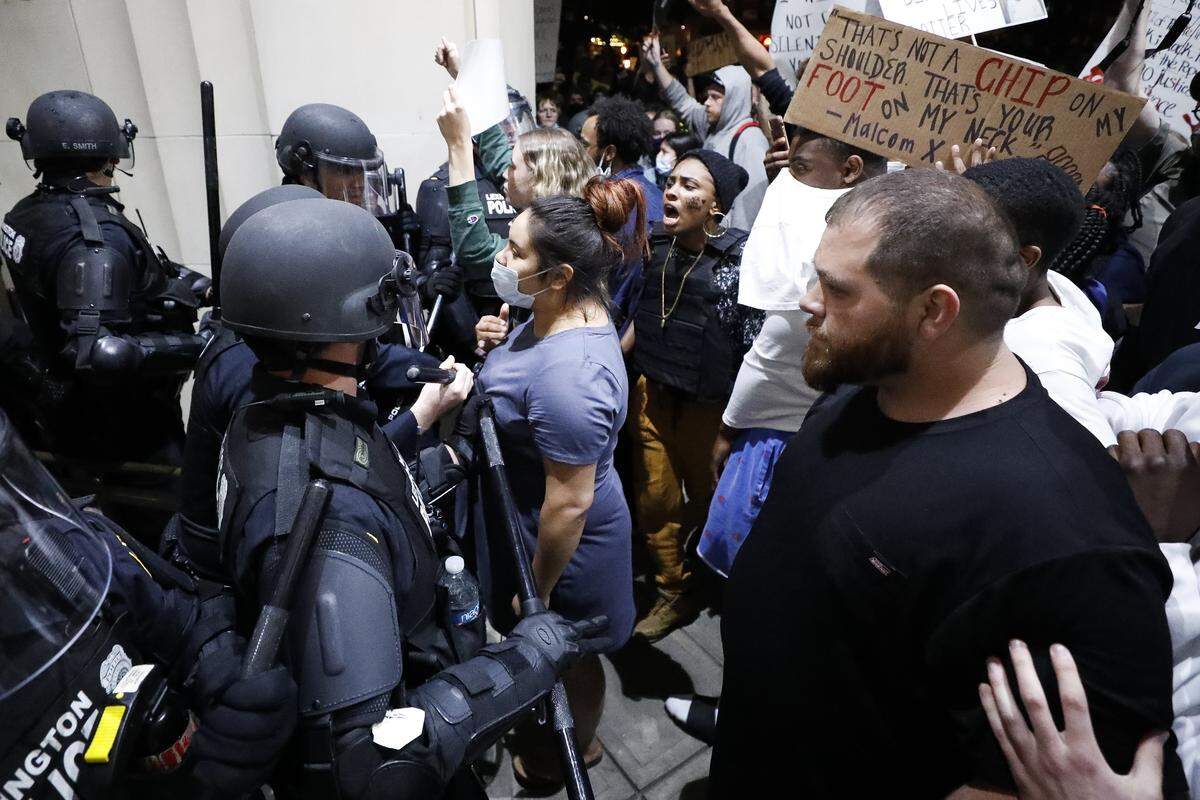 Lexington police officers and protesters briefly clash at the Fayette County District Court during the third night of protests in downtown Lexington on Sunday. The protests come amid a nationwide outcry over the deaths of George Floyd in Minneapolis and Breonna Taylor in Louisville, who both died at the hands of police.