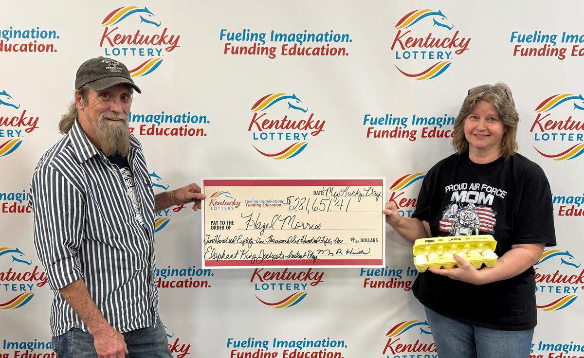 Hazel Morris poses with her husband Dale, showing off a large check made out with their Kentucky Lottery winnings. Hazel Morris won more than $281,000 playing the Elephant King instant play game.