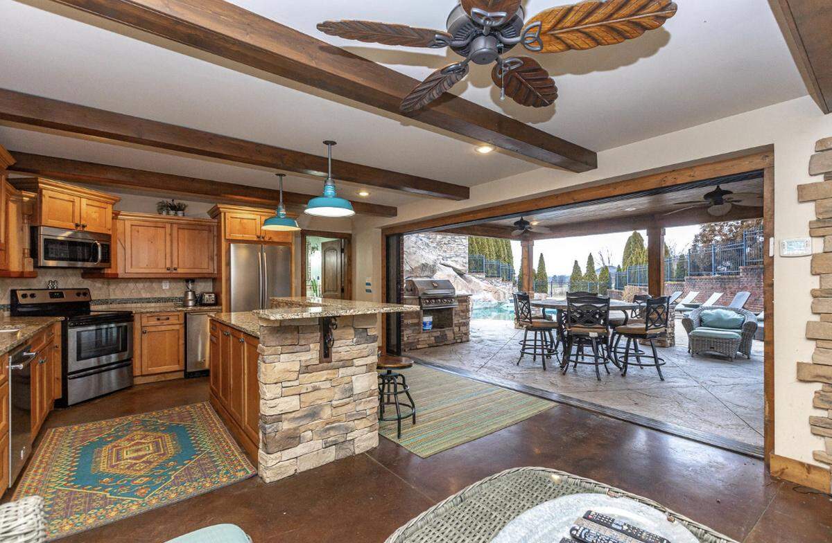 The home at 200 Kelburn Court features a separate pool house with a full kitchen and seating.