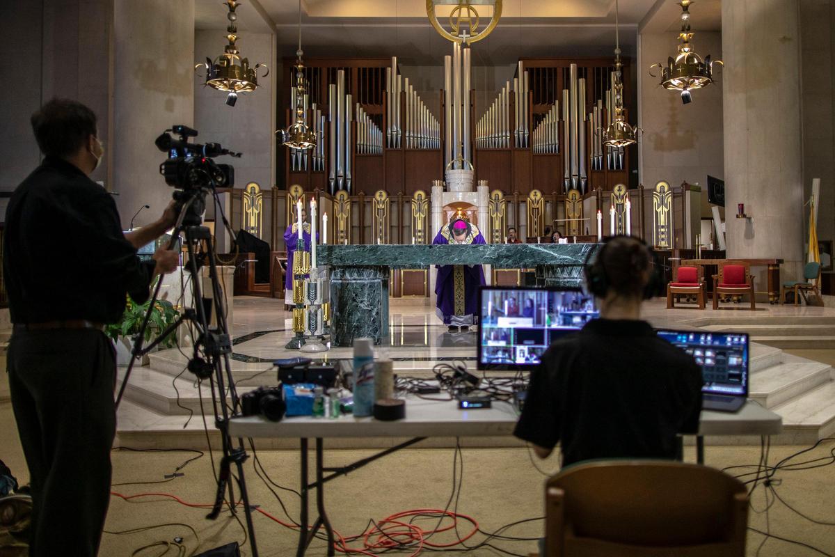 Bishop John Stowe celebrates Mass at Cathedral of Christ the King in Lexington, Ky., Sunday, March 29, 2020. The church is webcasting its services — which are temporarily closed to parishioners — in response to the coronavirus pandemic.