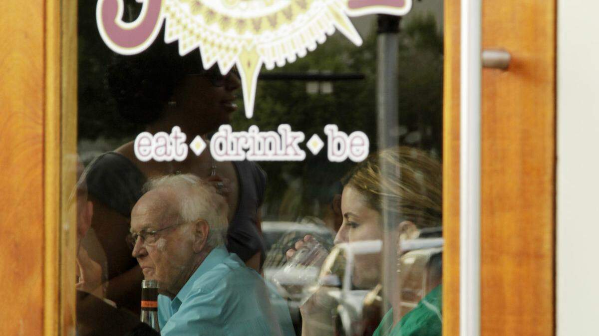 Diners seen through the door at The Jax restaurant on the busy corner of Short and Limestone in Lexington, Ky., on Aug. 23, 2013. Photo by Pablo Alcala | Staff 