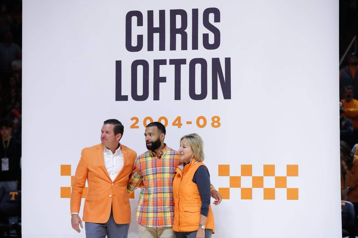 Chris Lofton poses for photos in front of his Tennessee jersey banner Saturday in Knoxville.