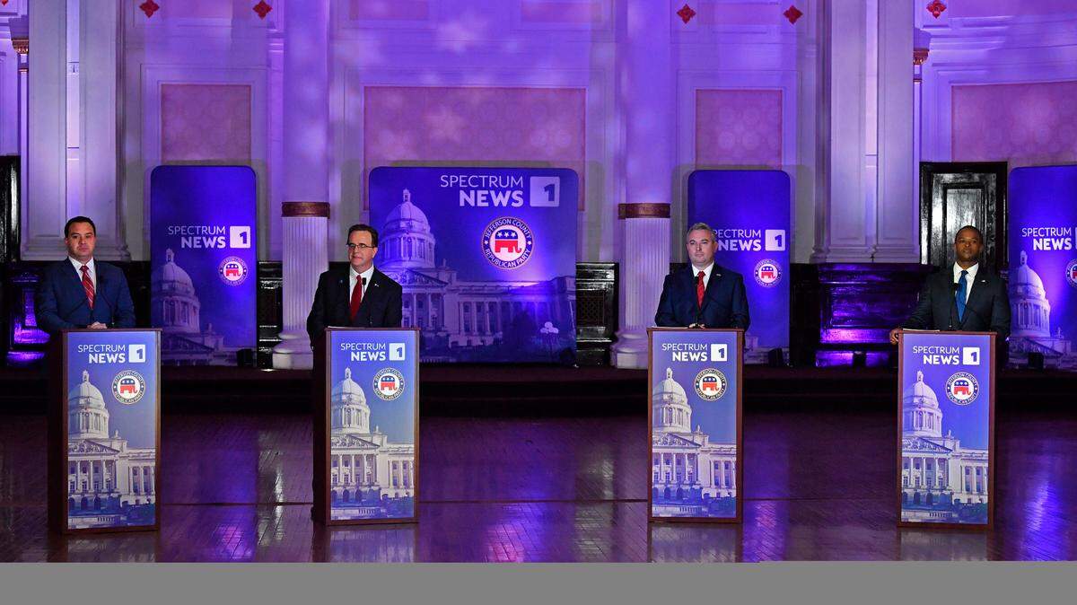 From left, Somerset, Ky., Mayor Alan Keck, Kentucky State Auditor Mike Harmon, Kentucky Agricultural Commissioner Ryan Quarles and Kentucky Attorney General Daniel Cameron prepare for the start of the Kentucky Gubernatorial GOP Primary Debate in Louisville, Ky., Tuesday, March 7, 2023. (AP Photo/Timothy D. Easley, Pool)