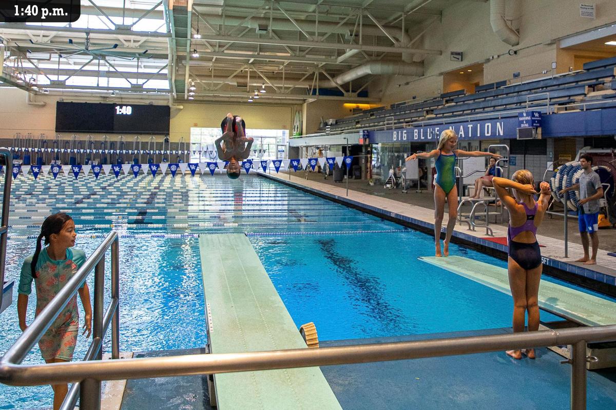Will Darnell performs a double front somersault into the water Friday, July 9 during the University of Kentucky’s Diving Camp at Lancaster Aquatic Center. The three-day camp only had six participants, designed to focus on athlete to coach ratio. Ages ranged from 8 to 14 with levels ranging from beginners to those of recruiting level.. Campers used video feedback to analyze technique and refine skills..