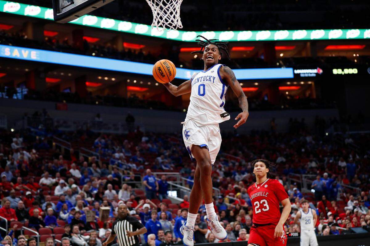 Kentucky freshman Rob Dillingham (0) throws down a dunk against Louisville during Thursday’s game at the KFC Yum Center.