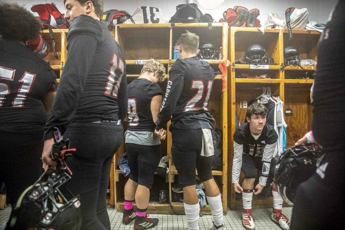 Harlan County players get ready in their locker room before taking on Perry County.