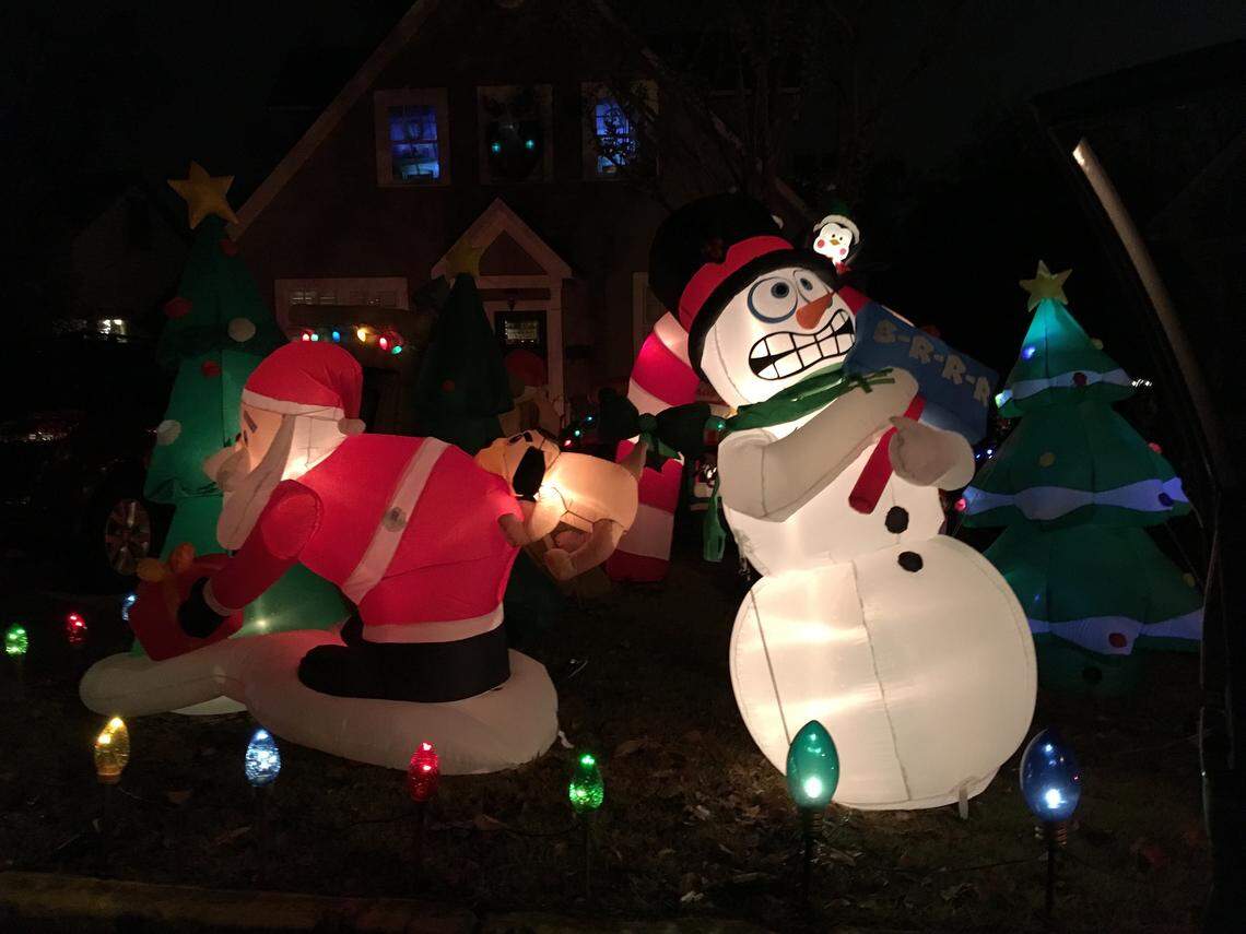 Santa encounters a vigilant guard dog at the Pup House. A snowman shivers next to him. Around the corner is a Mr. Potato Head Santa family.