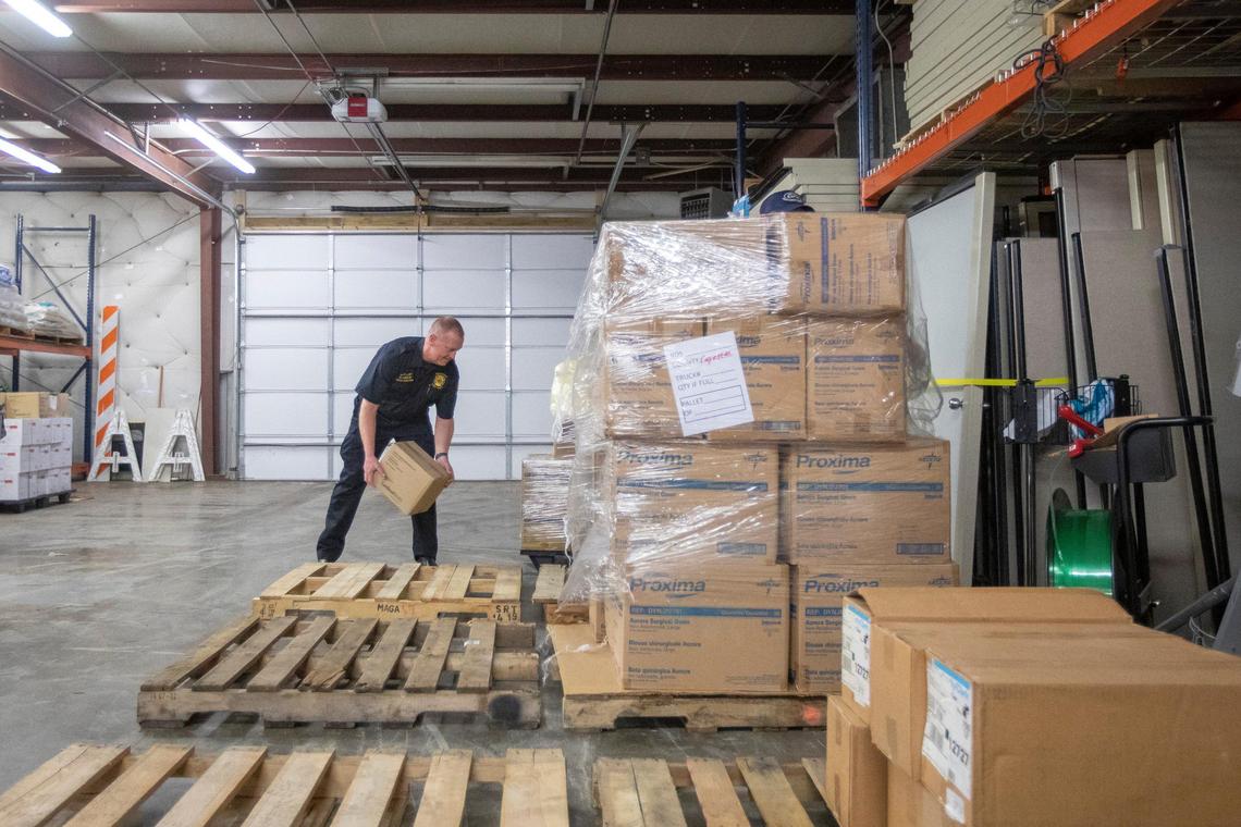 Lexington Fire Department Battalion Chief Rob Larkin sorts supplies delivered to the Lexington-Fayette County Health Department on Wednesday, March 18, 2020. Fayette County received 27 pallets of personal protective equipment from the Strategic National Stockpile and state cache Wednesday.